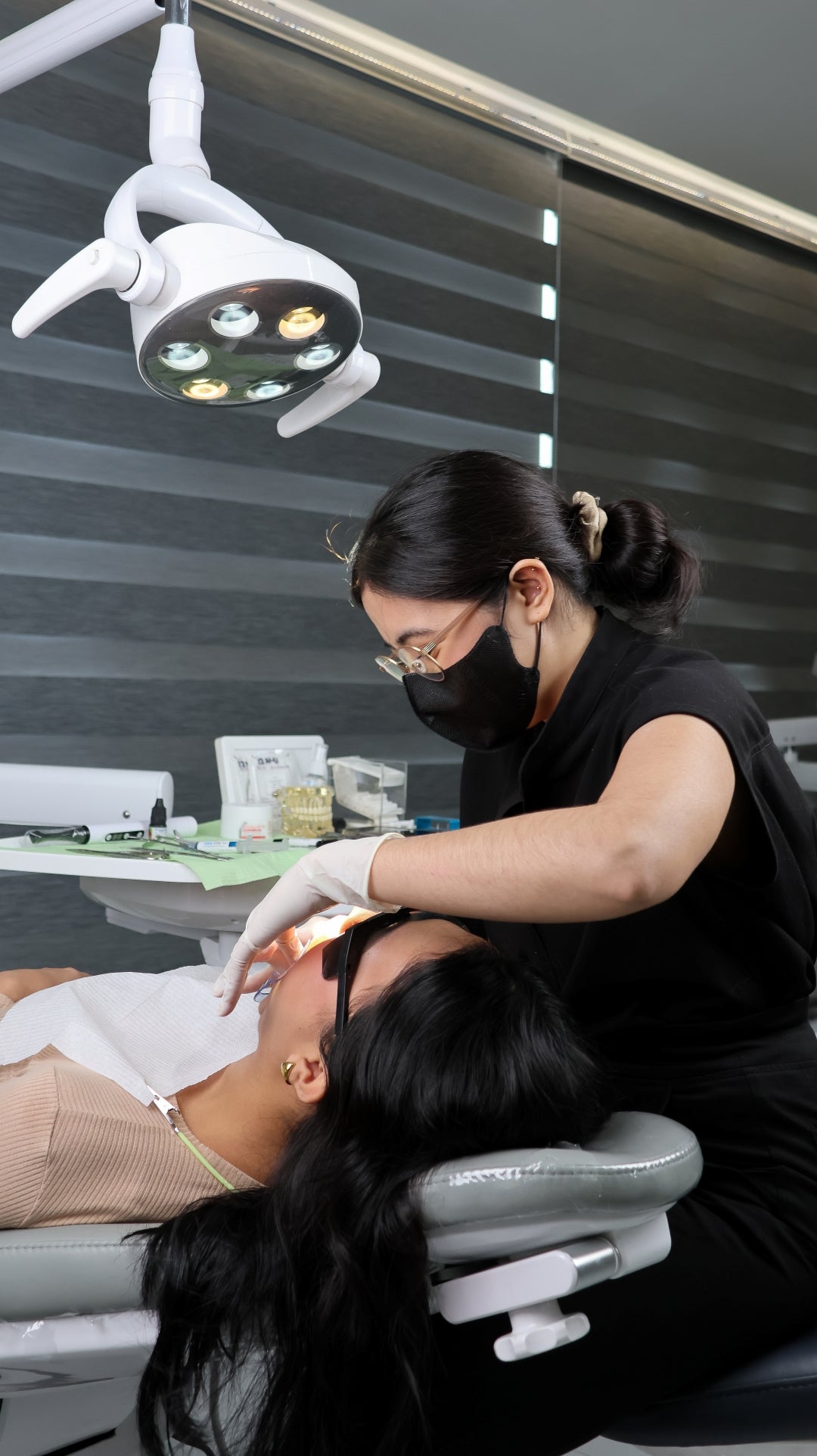 Dental professional examining a patient in a dental office.